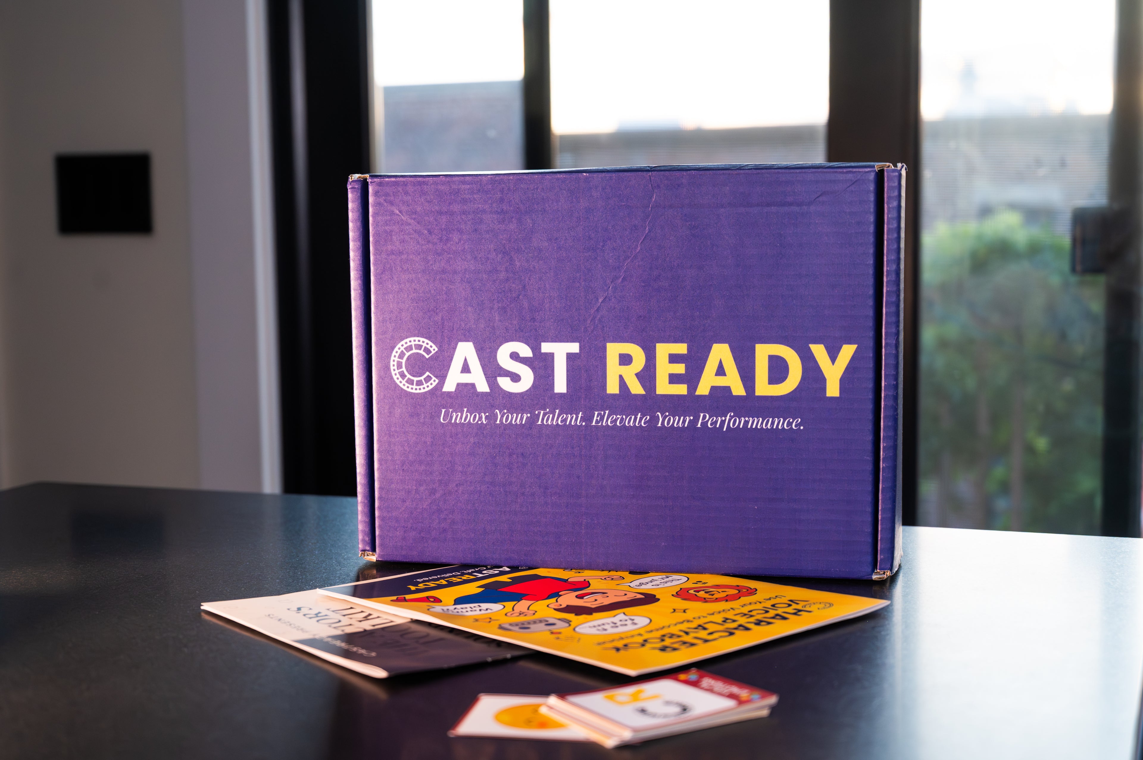 CastReady acting education kit box and learning materials on a kitchen table, ready to be opened at home